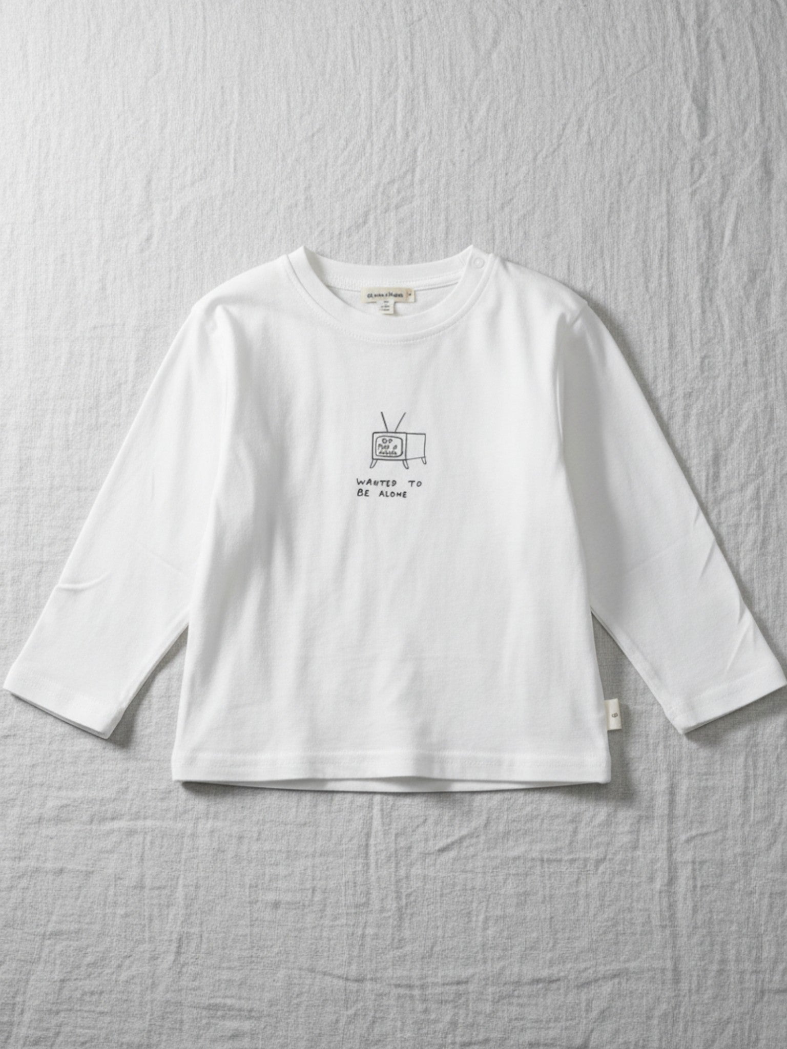 Children's white long-sleeve t-shirt featuring a small black line drawing of a vintage television with "WANTED TO BE ALONE" printed underneath.