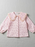 Girls' pink and white seersucker blouse featuring a bow print, a large frilled Peter Pan collar, and elasticated ruffle cuffs.