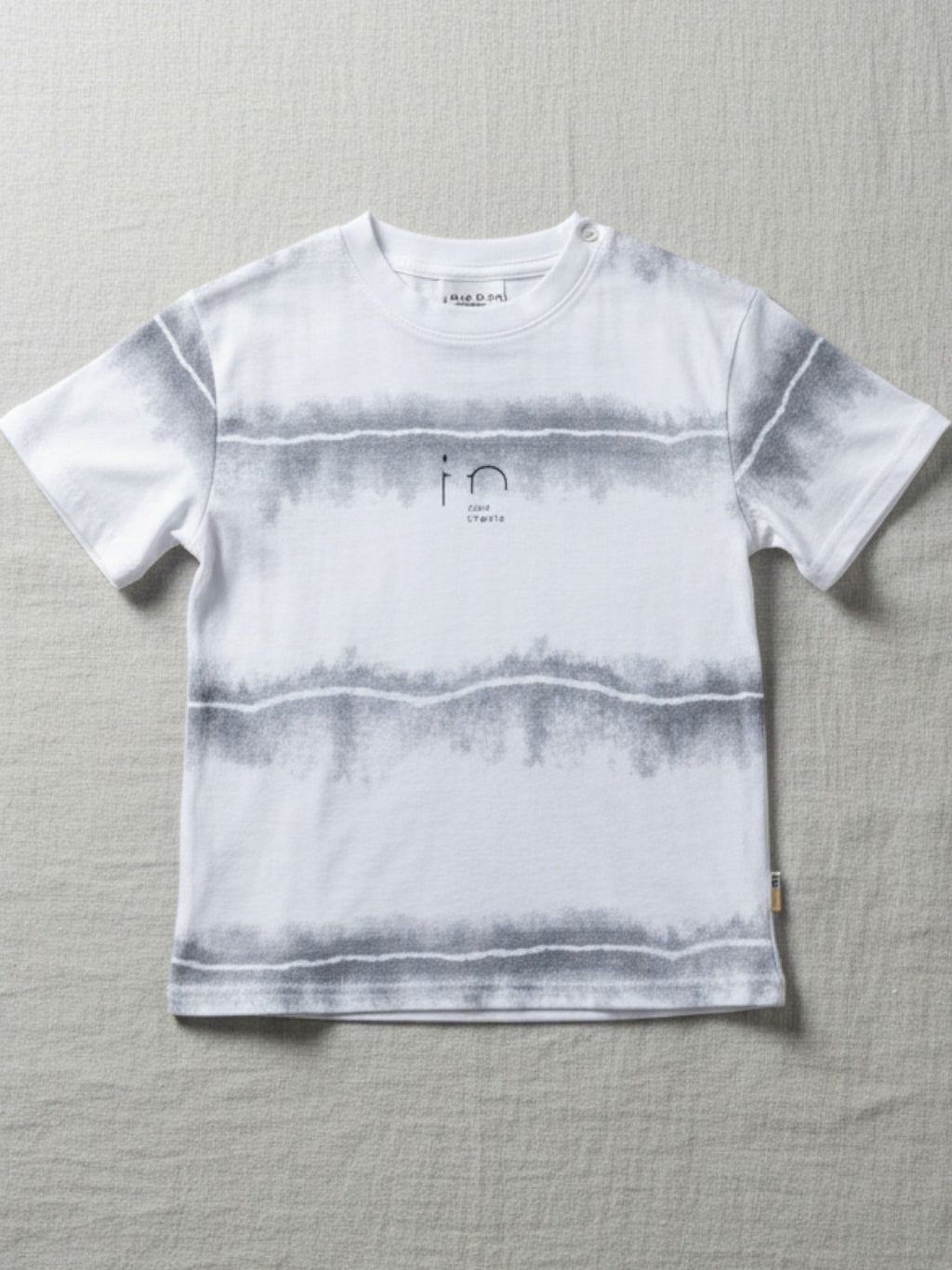 Children's white short-sleeve t-shirt featuring three horizontal gray watercolor-effect stripes and a minimalist "in" graphic on the chest.