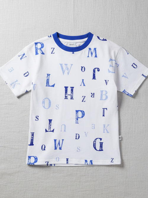 Children's white short-sleeve t-shirt with a blue crew neck, featuring a scattered print of various alphabet letters in shades of blue.
