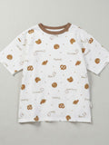 Children's white short-sleeve t-shirt with a brown crew neck, featuring a tossed print of pretzels, croissants, and bear faces with "Pretzel" and "Croissant" text.