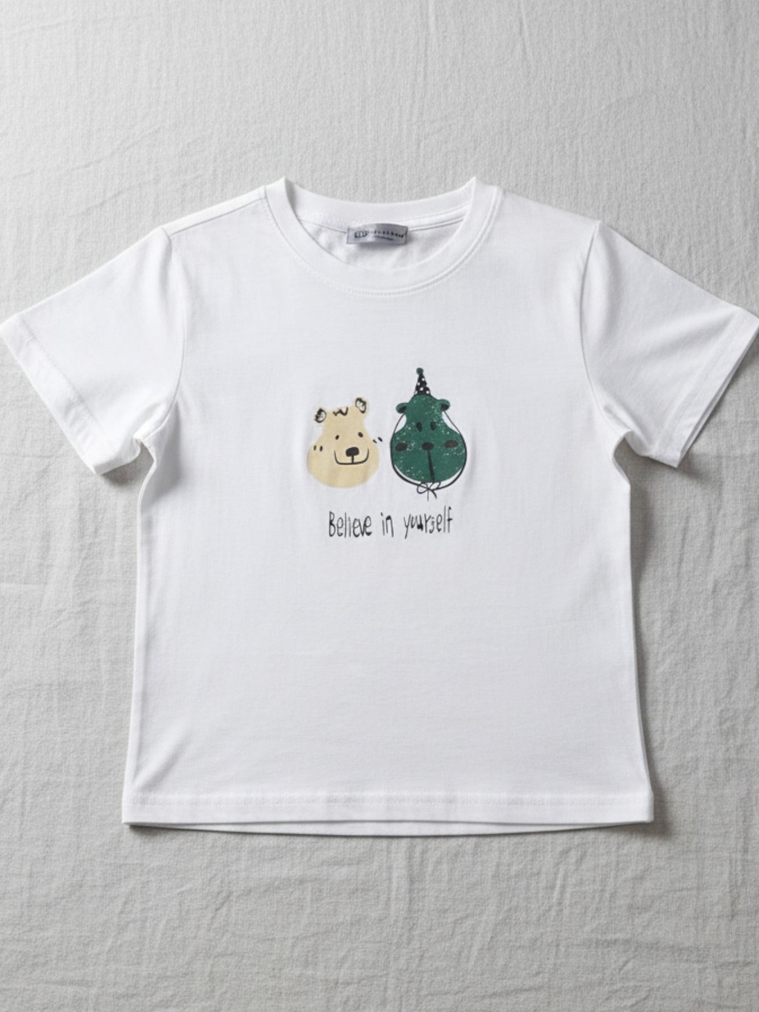 kids cute. White t-shirt with cartoon bear and dragon design on a gray background
