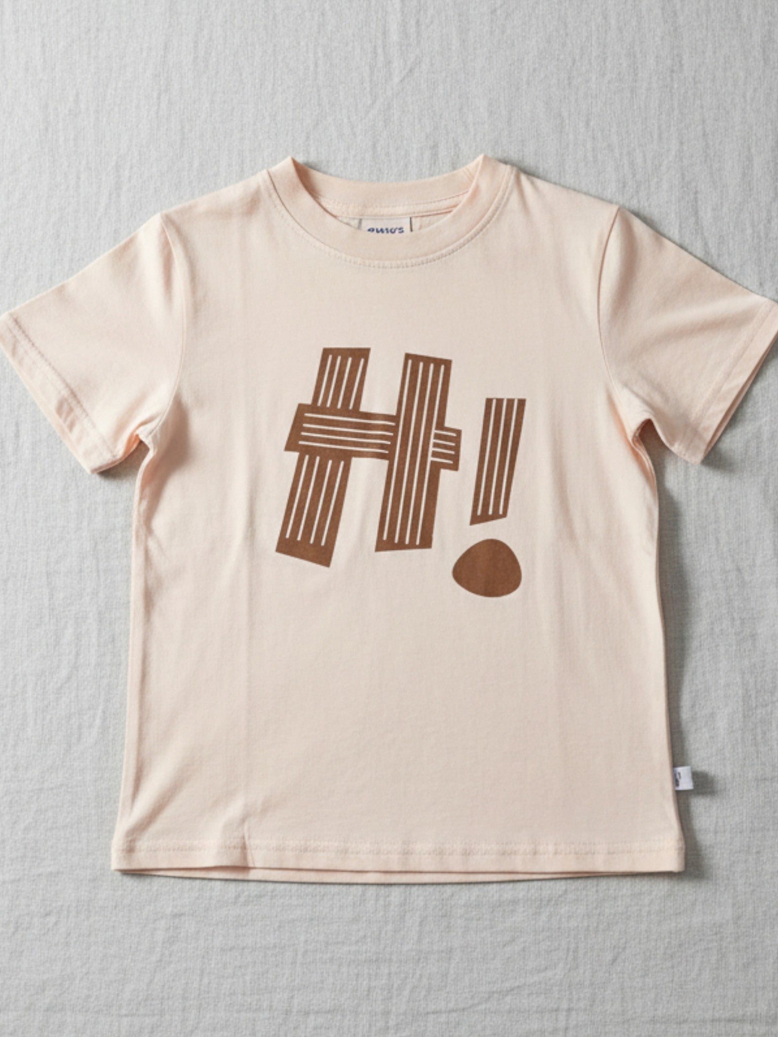 Kids Beige t-shirt with brown 'HI!' print High-quality and affordable kids wear from Australia, featuring clothing everyday play, dress up events or for the playground. machine-washable cotton. perfect blend of style and durability for boys and girls. Easy care kids clothes. Toddler/child [item] Australia. Affordable kids wear



