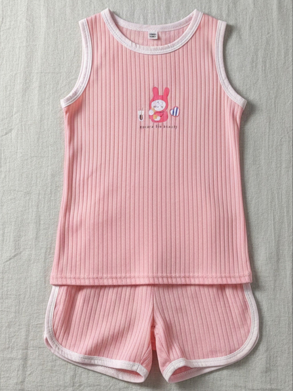 Pink ribbed cotton tank and shorts set for kids with white contrast trim and pink bunny "Record the Beauty" graphic.