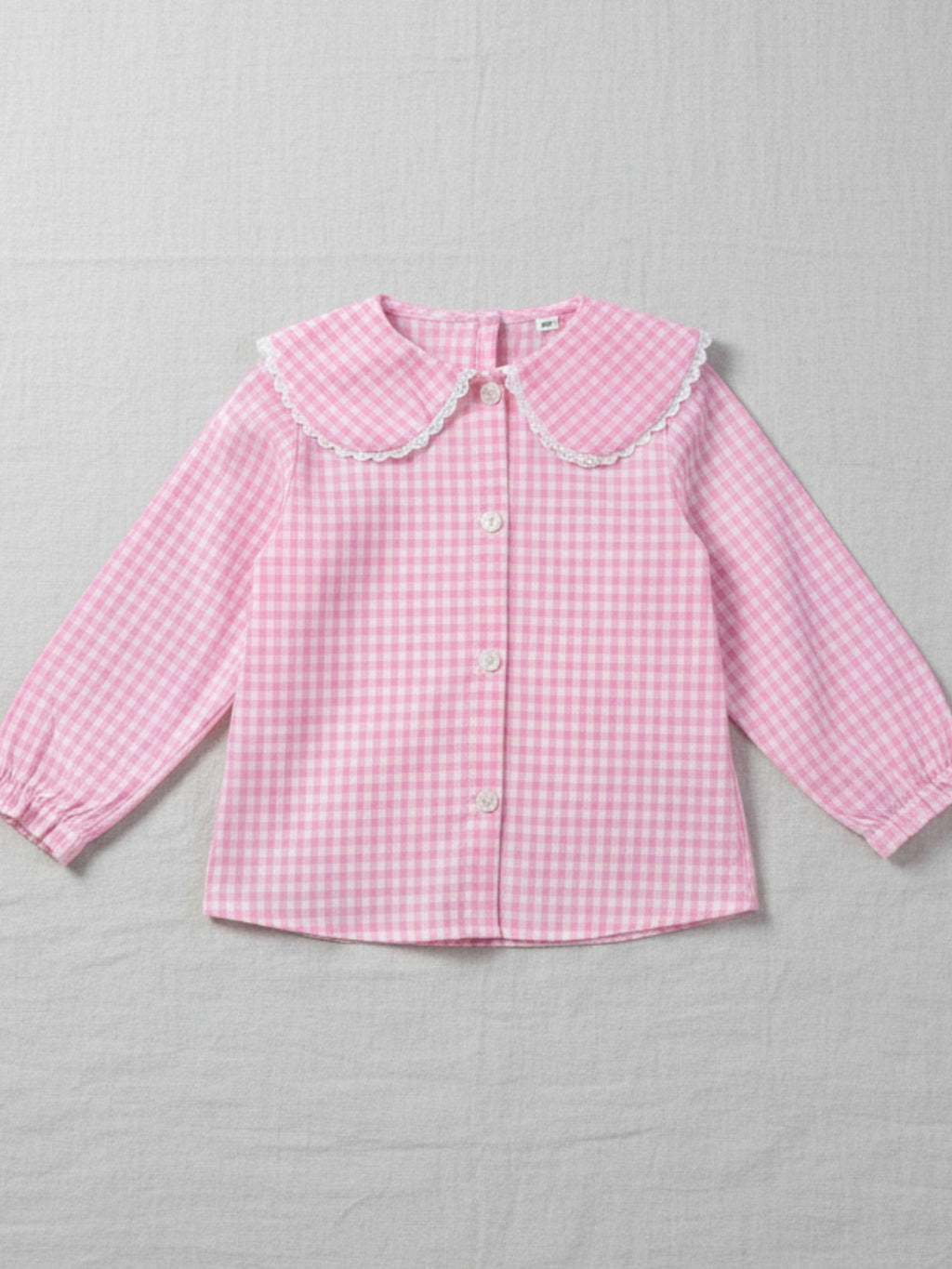 Girls' pink and white gingham long-sleeve blouse featuring a wide scalloped collar, puff sleeves, and a button-down front.
