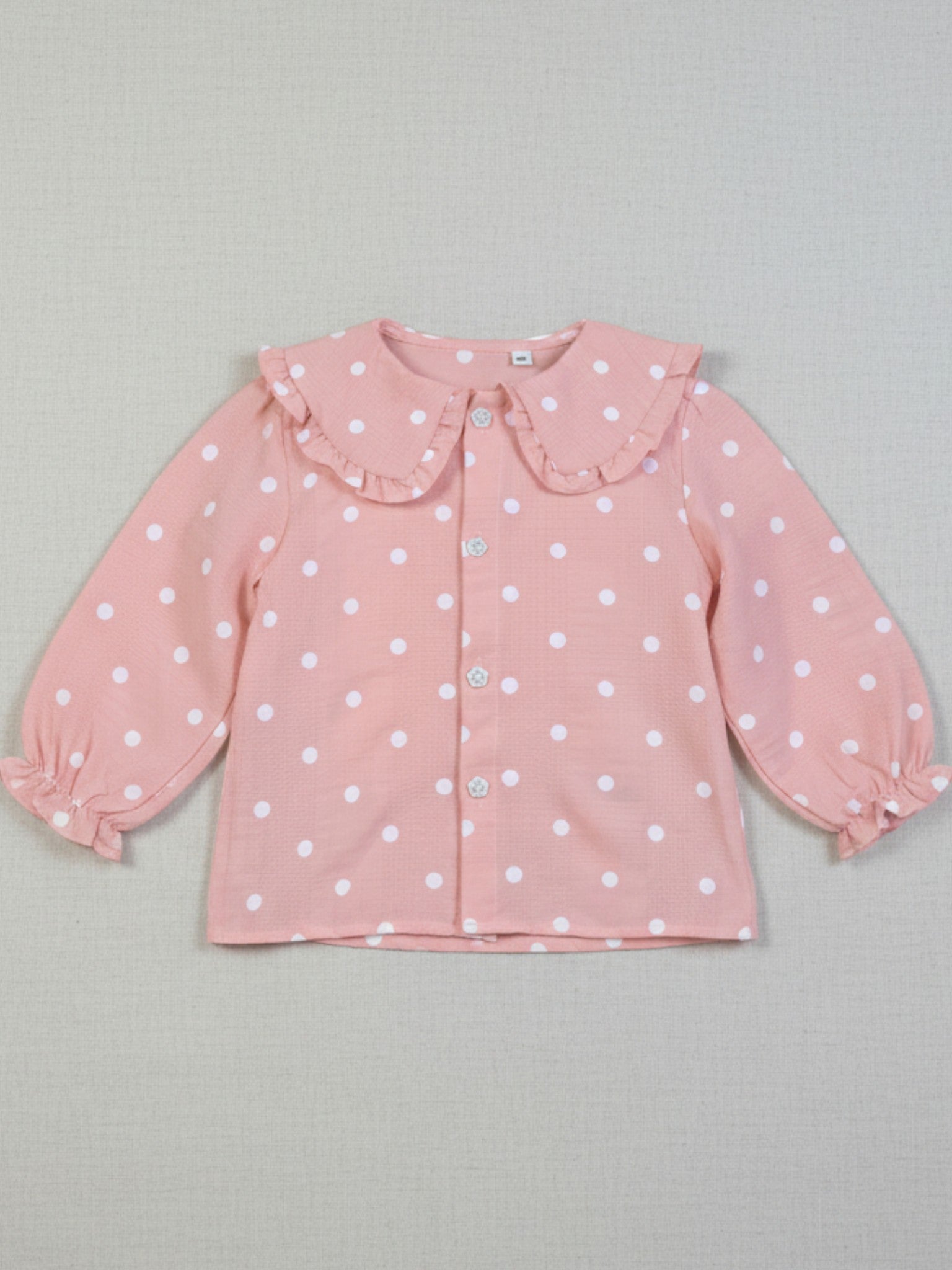 Pink polka dot blouse with a ruffled collar
