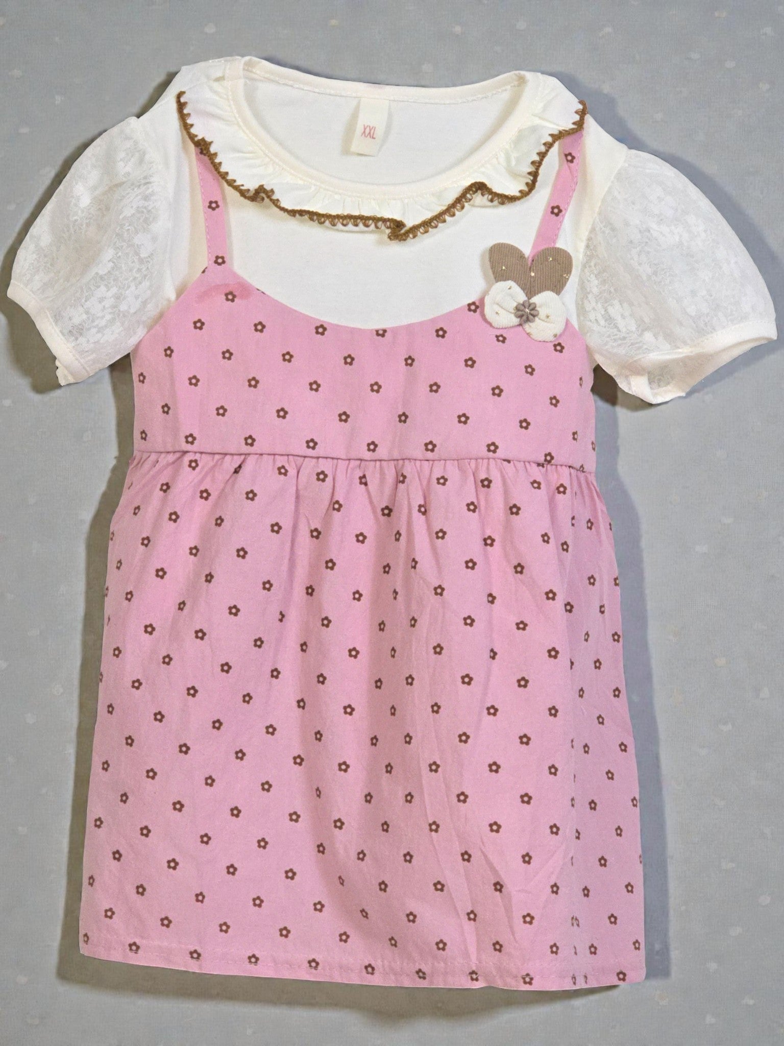 Pink dress with white lace top on a gray background. Pink 3