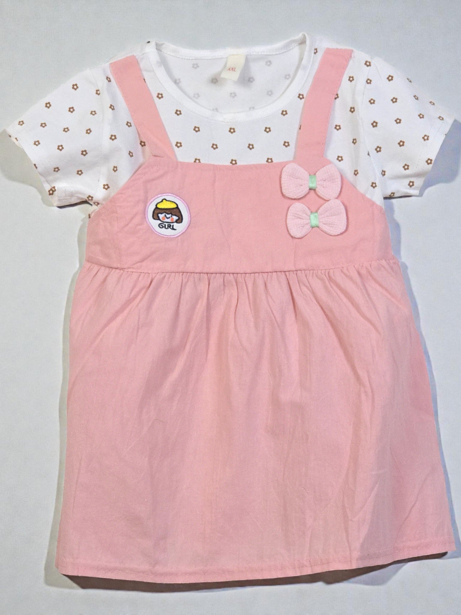 Pink dress with a bow and white shirt with gold polka dots on a light gray background. Pink 5