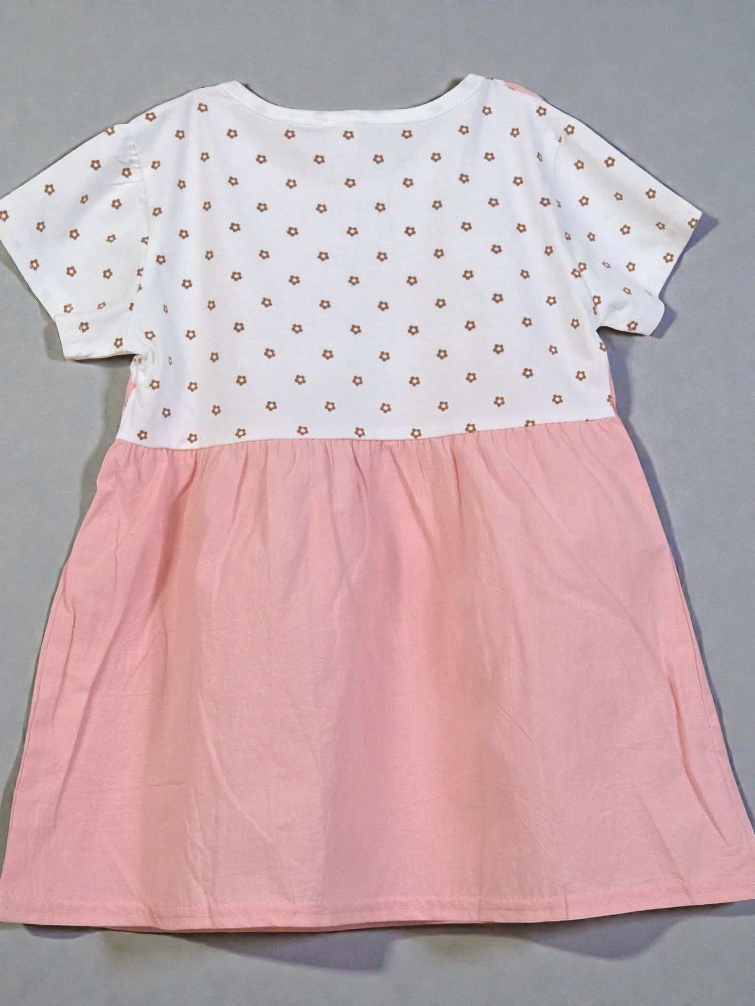 Two-tone dress with white top and pink skirt on a gray background. Pink 5