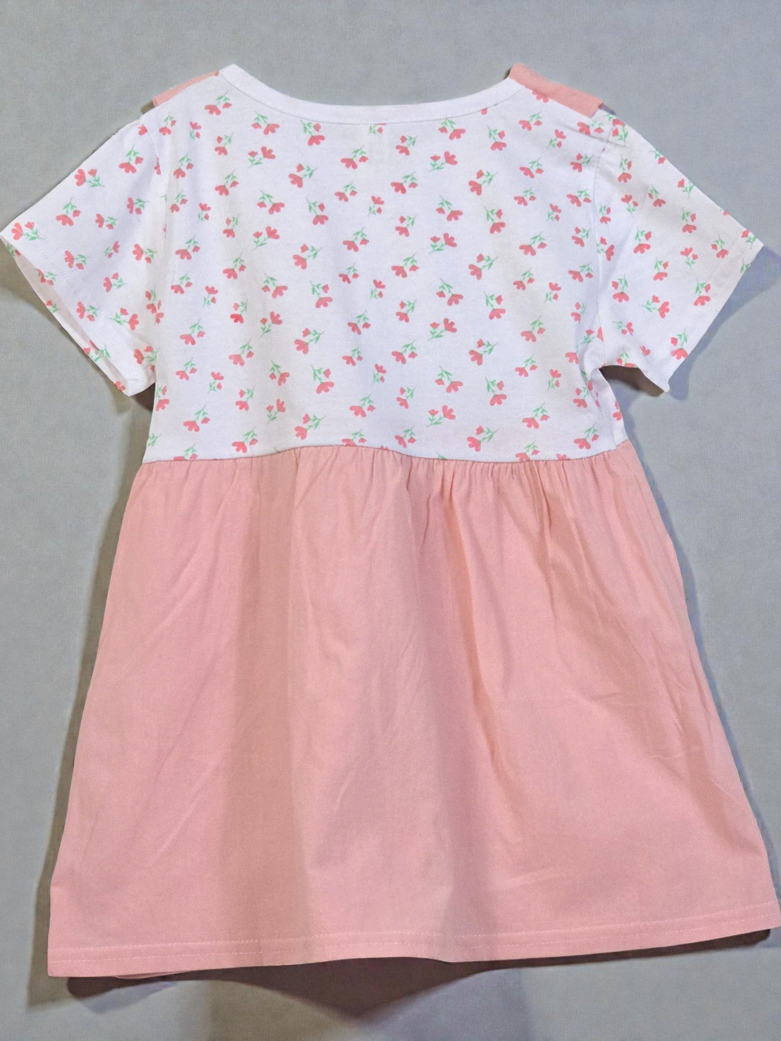 Pink dress with floral pattern on a gray background. Pink 7