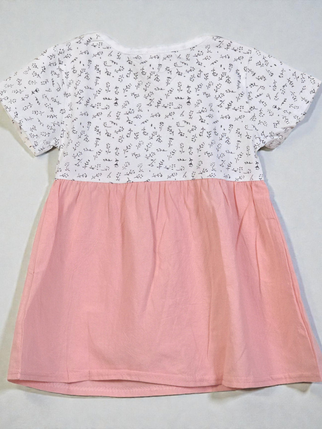 Two-tone dress with floral top and pink skirt on a light gray background. Pink 8