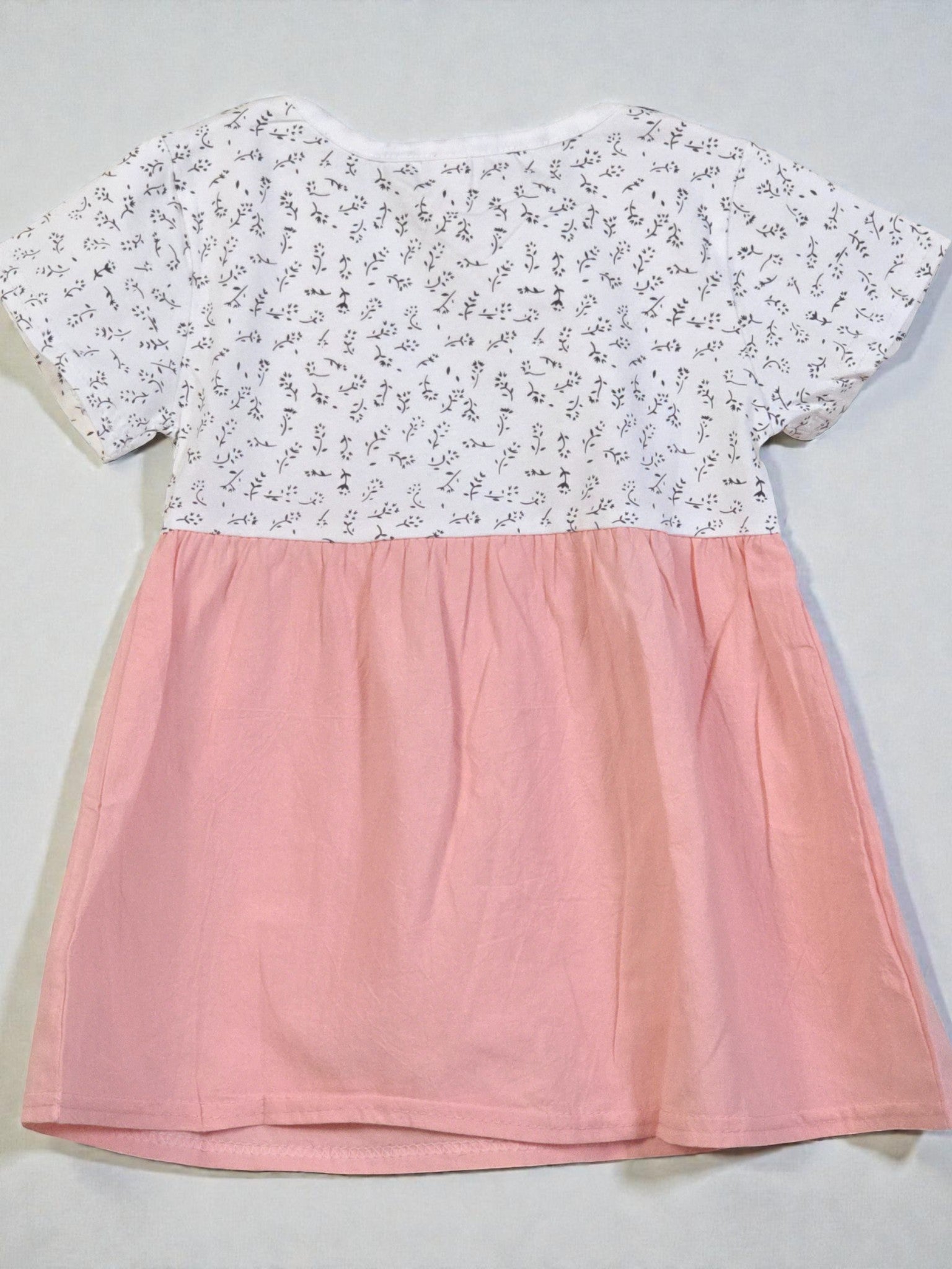 Two-tone dress with floral top and pink skirt on a light gray background. Pink 8