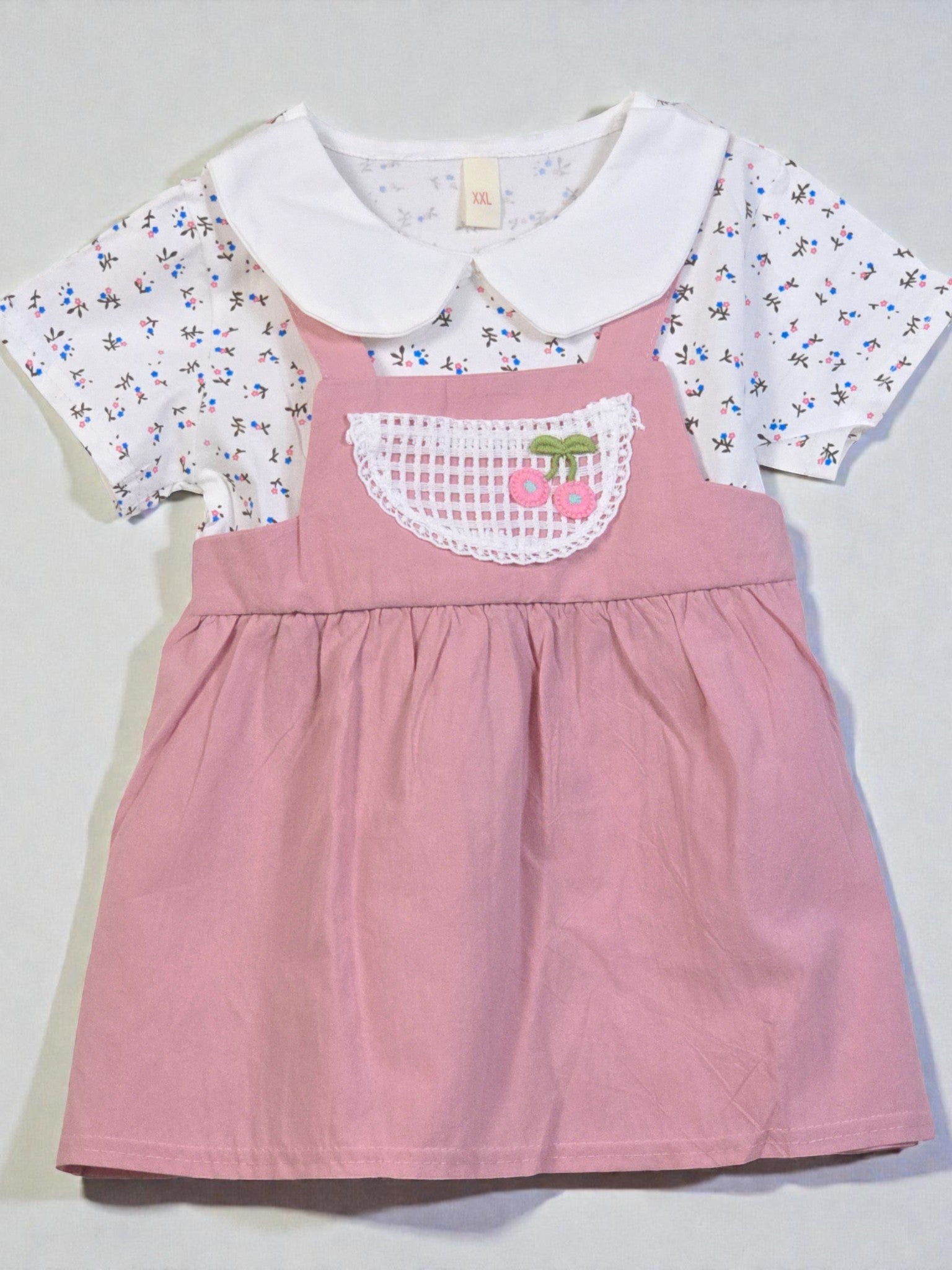 Pink dress with floral collar and white shirt on a light gray background. Pink 10