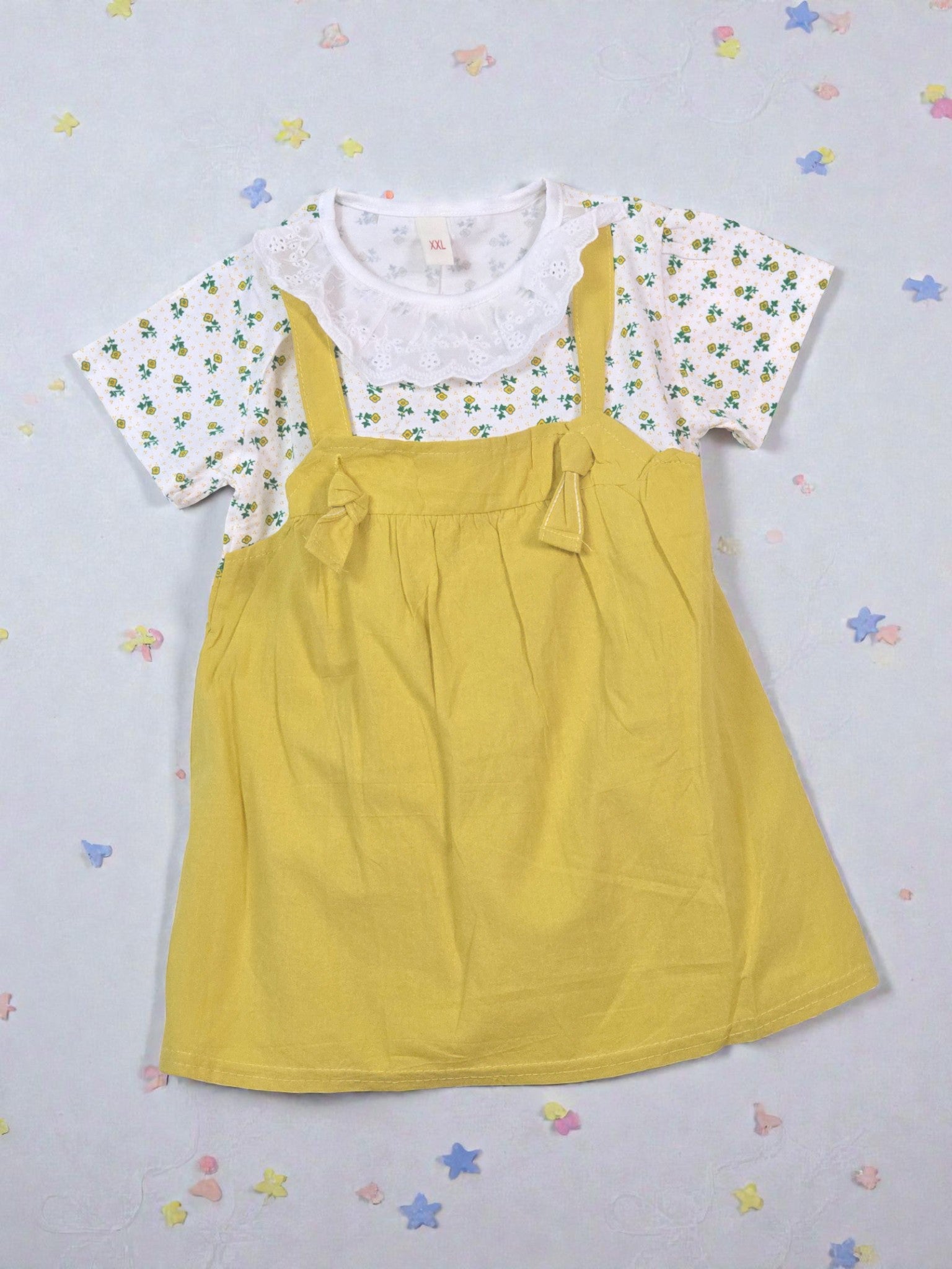 Yellow dress with floral top on a light gray background. Yellow