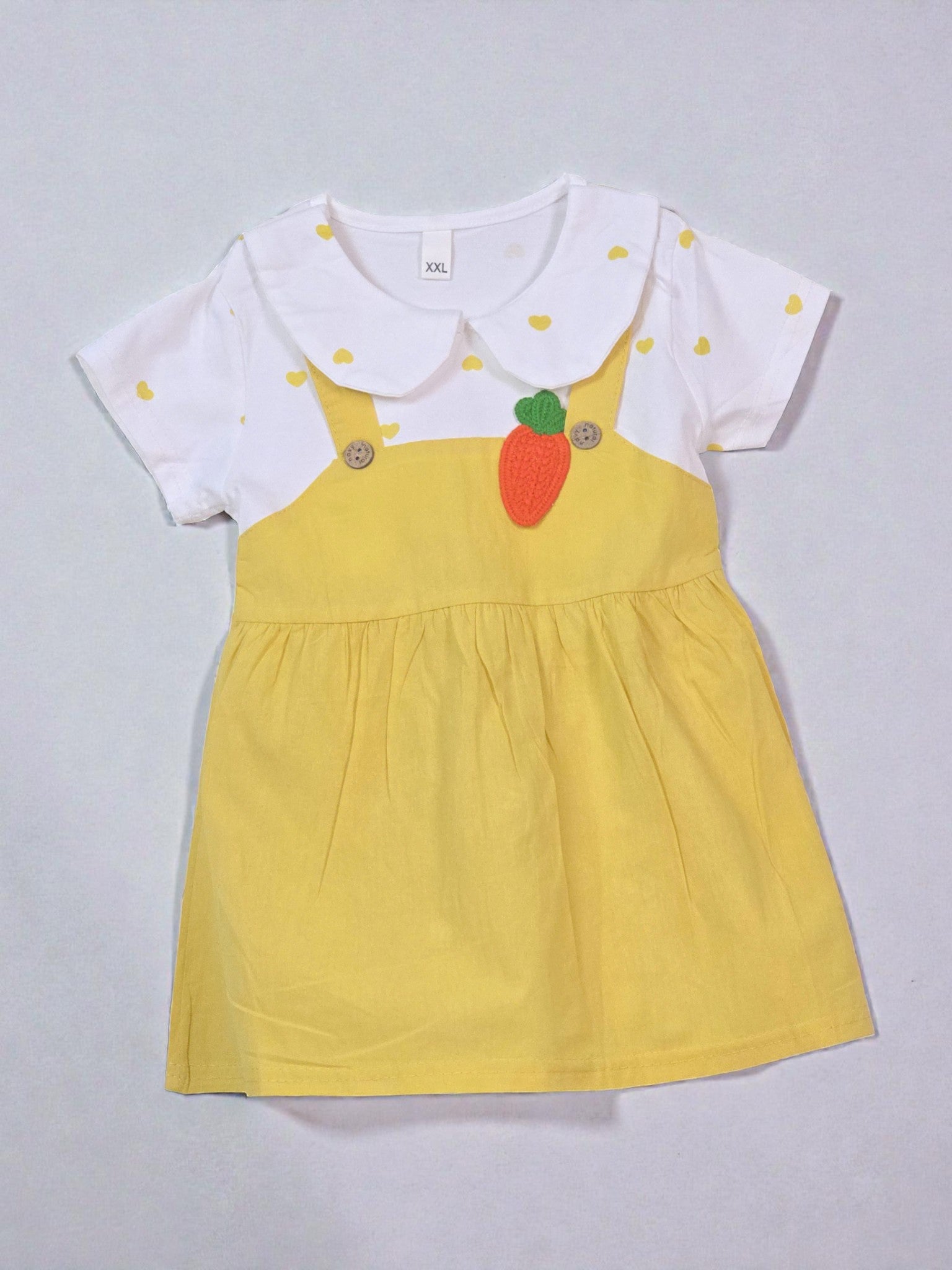 Yellow dress with white collar and red carrot design on a gray background. Carrot