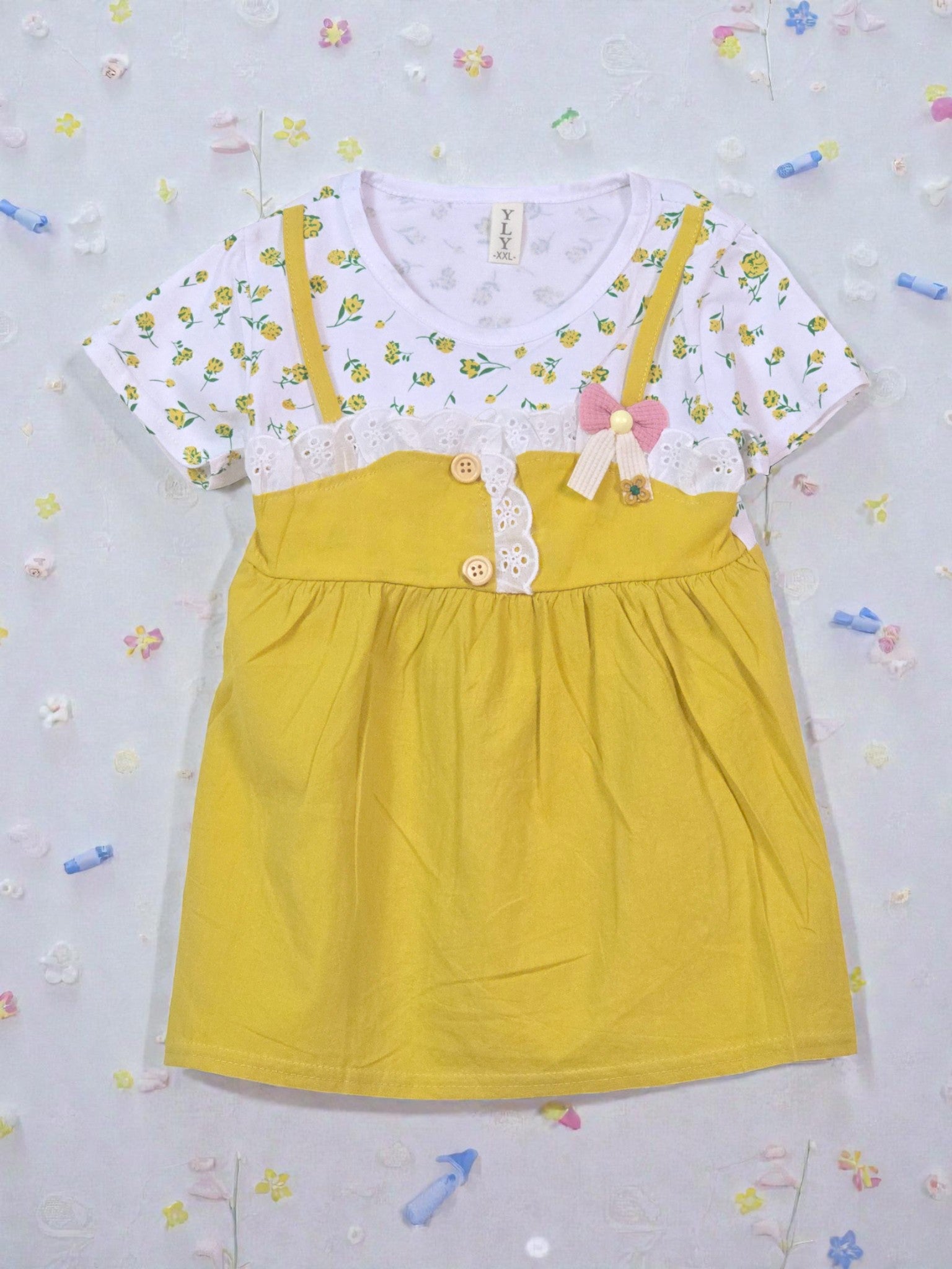 Yellow dress with a white floral top on a light gray background. Daisy