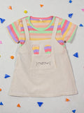Colorful striped shirt with a beige apron on a light gray background with colorful confetti. Rainbow