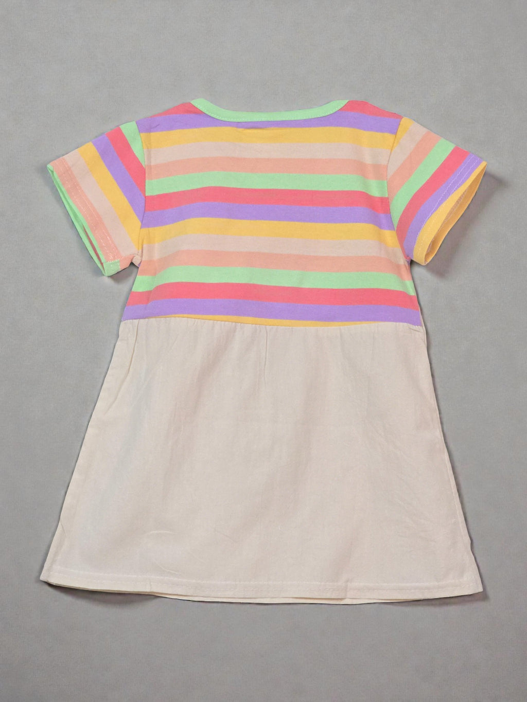Colorful striped shirt with a beige apron on a light gray background with colorful confetti. Rainbow