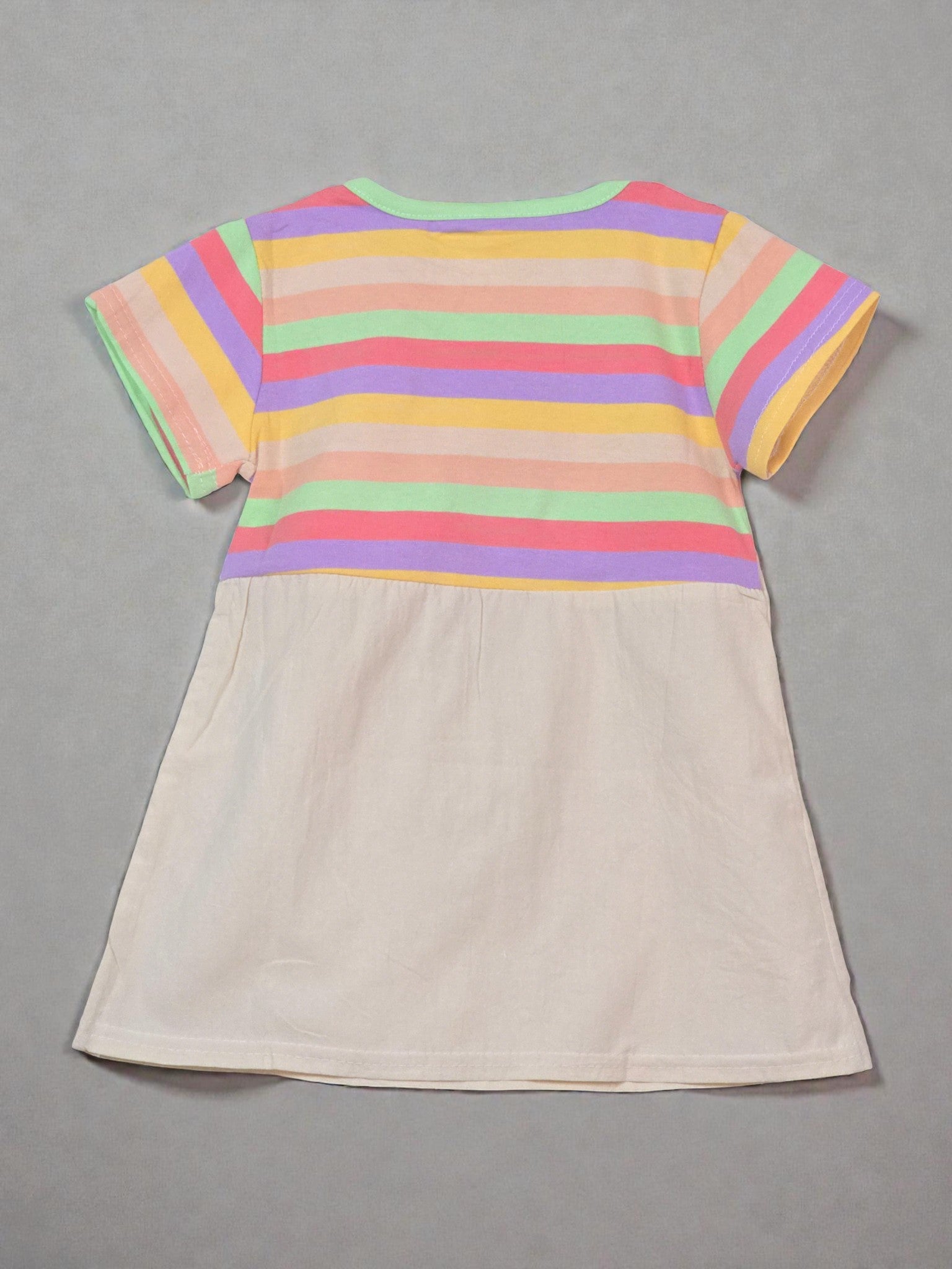 Colorful striped shirt with a beige apron on a light gray background with colorful confetti. Rainbow