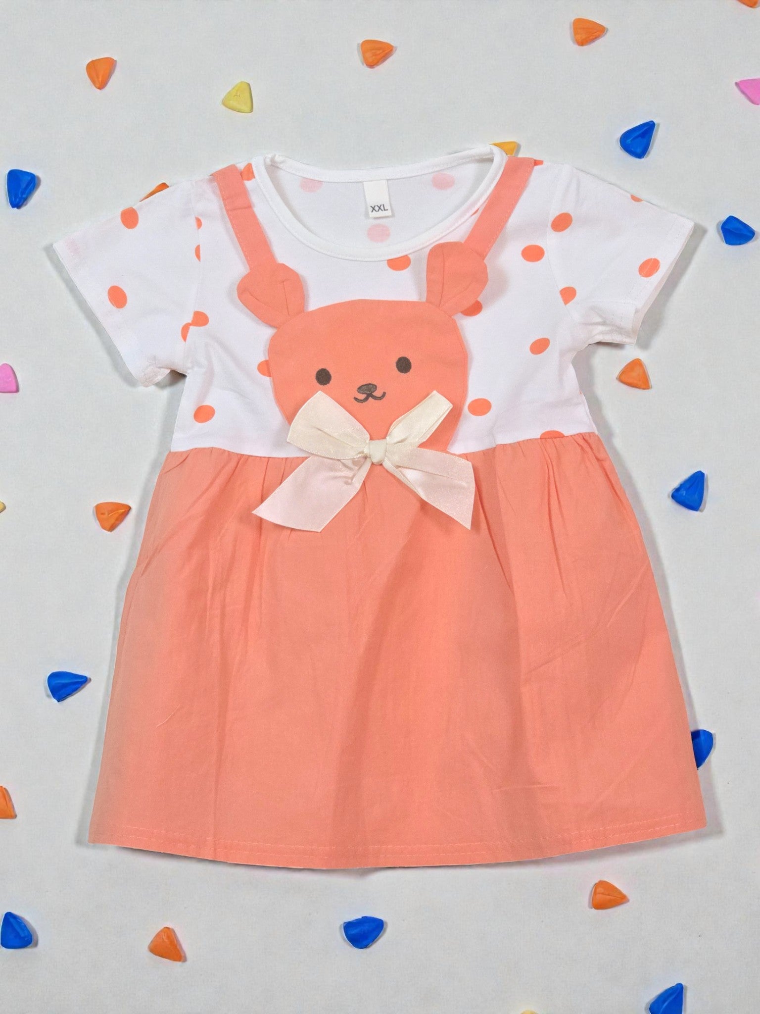 Children's dress with bear design on a light gray background with colorful confetti. Tangerine