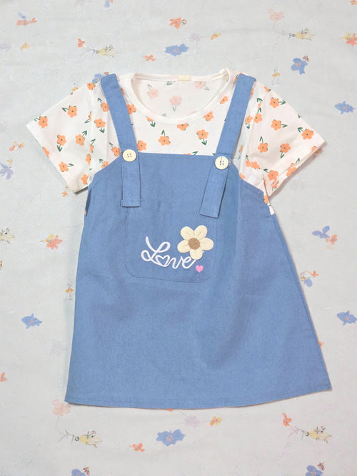 Blue pinafore dress with floral top on a light gray background Dark blue