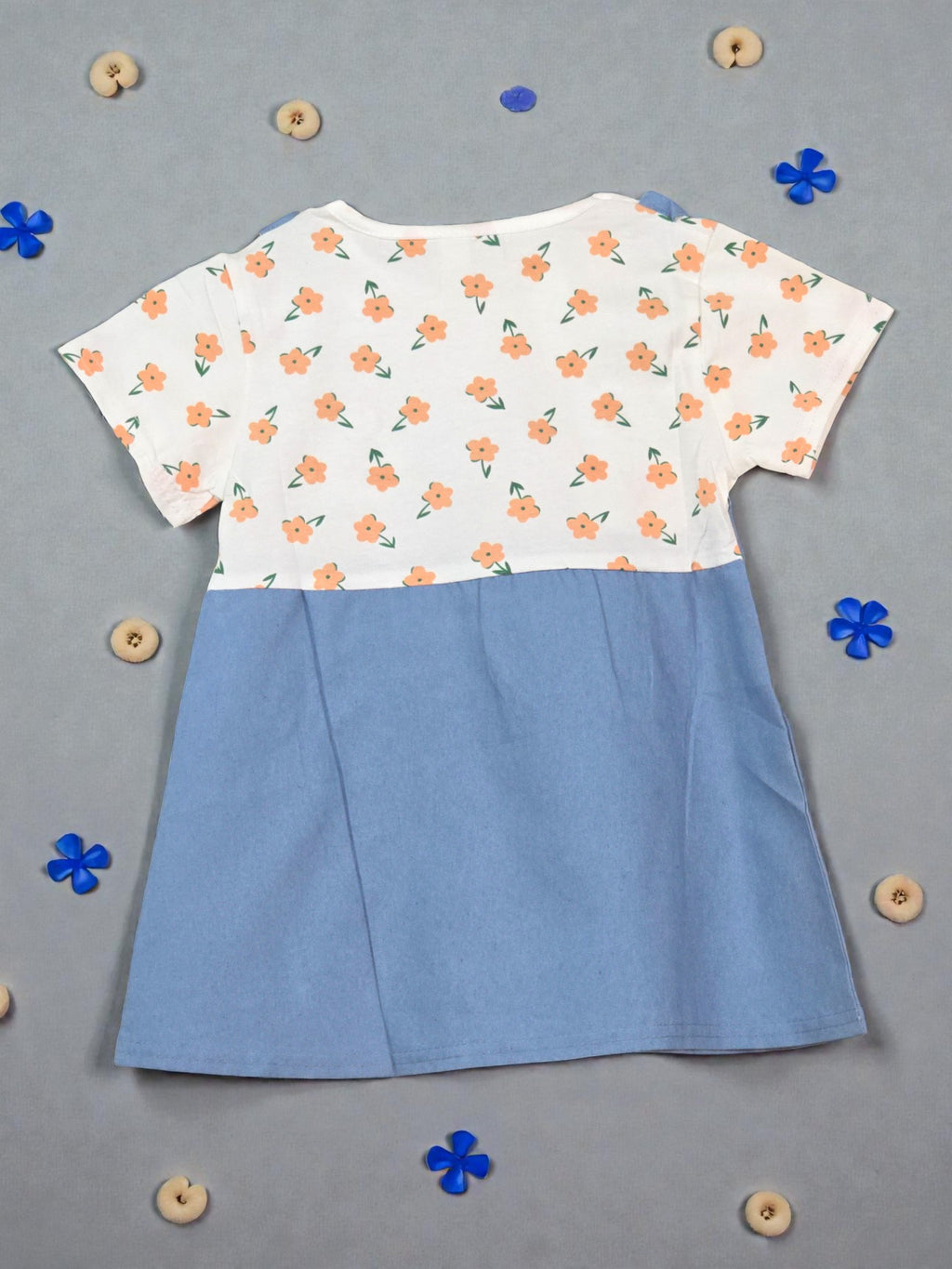 Blue pinafore dress with floral top on a light gray background Dark blue