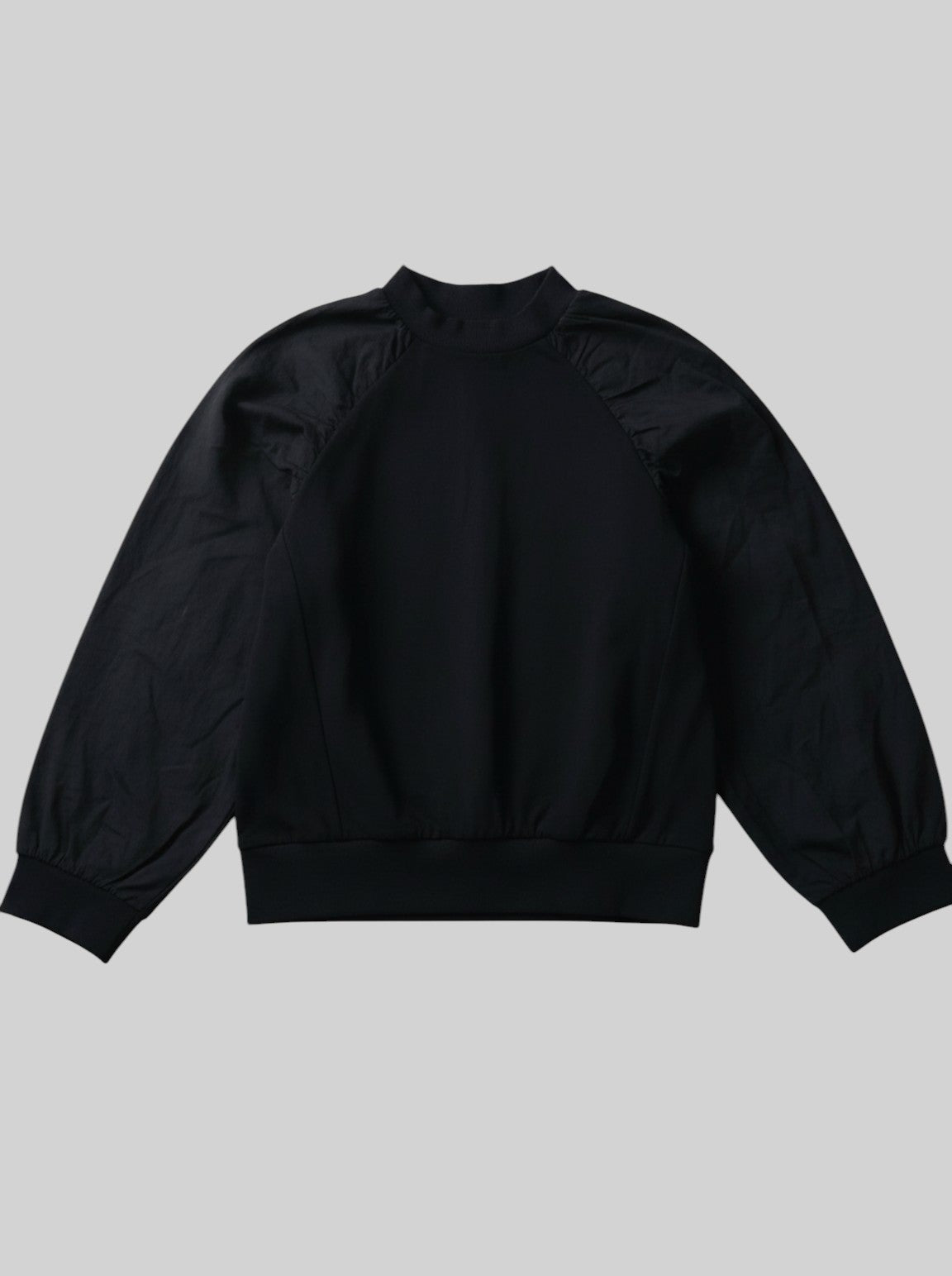 unisex kids black long-sleeve top featuring a soft jersey bodice and contrasting puff sleeves with gathered shoulders and elasticated cuffs