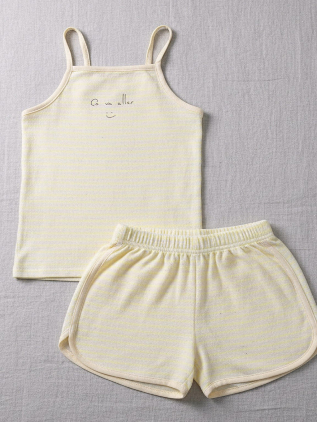 Kids yellow and white striped cami and shorts set with "Ça va aller" smiley face and colorful speckled cotton fabric.
