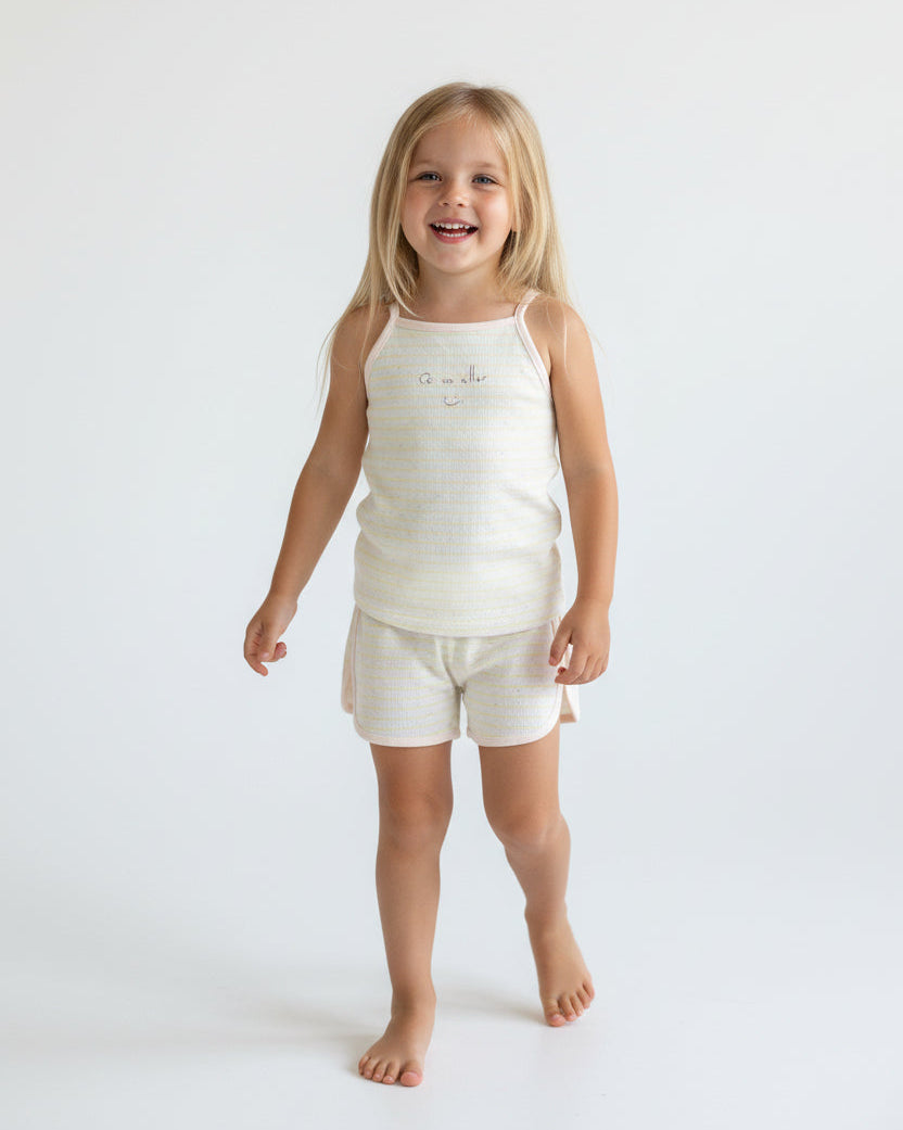 Kids yellow and white striped cami and shorts set with "Ça va aller" smiley face and colorful speckled cotton fabric.