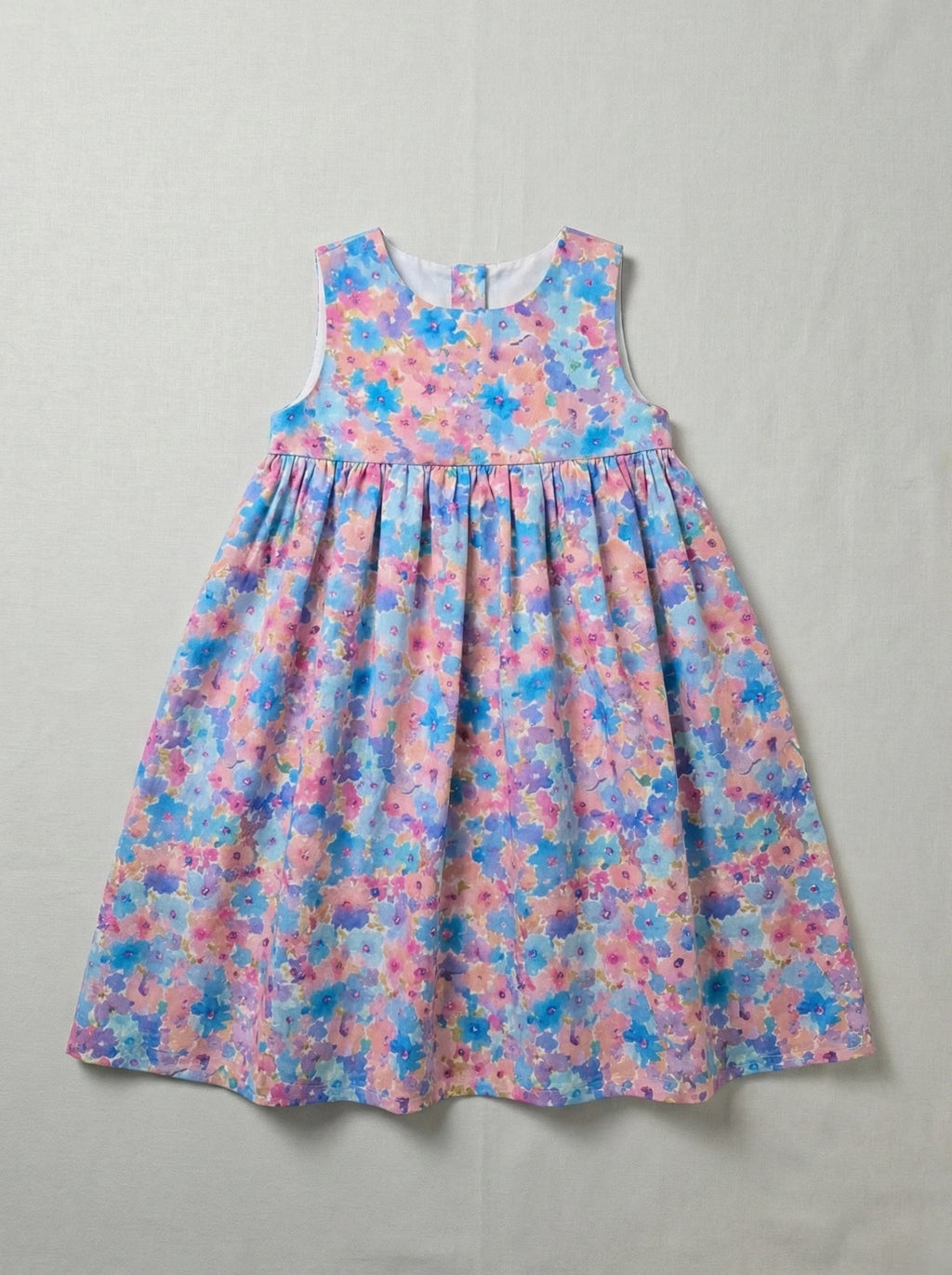 Half Moon Clothing sleeveless kids' dress with a vibrant blue and pink floral print, breathable and high-quality fabric for a designer-esque look.