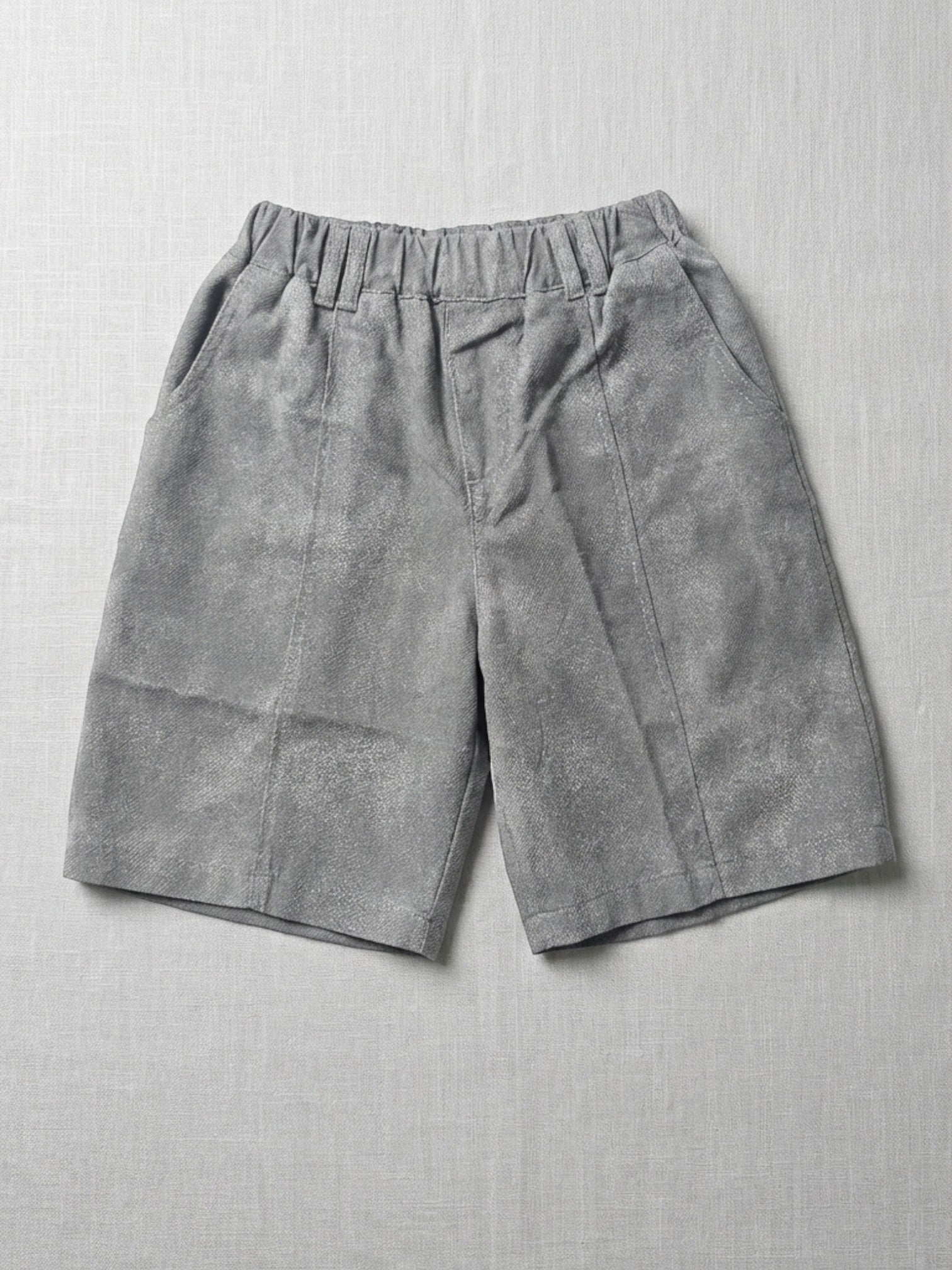 Gray shorts on a light gray textured background