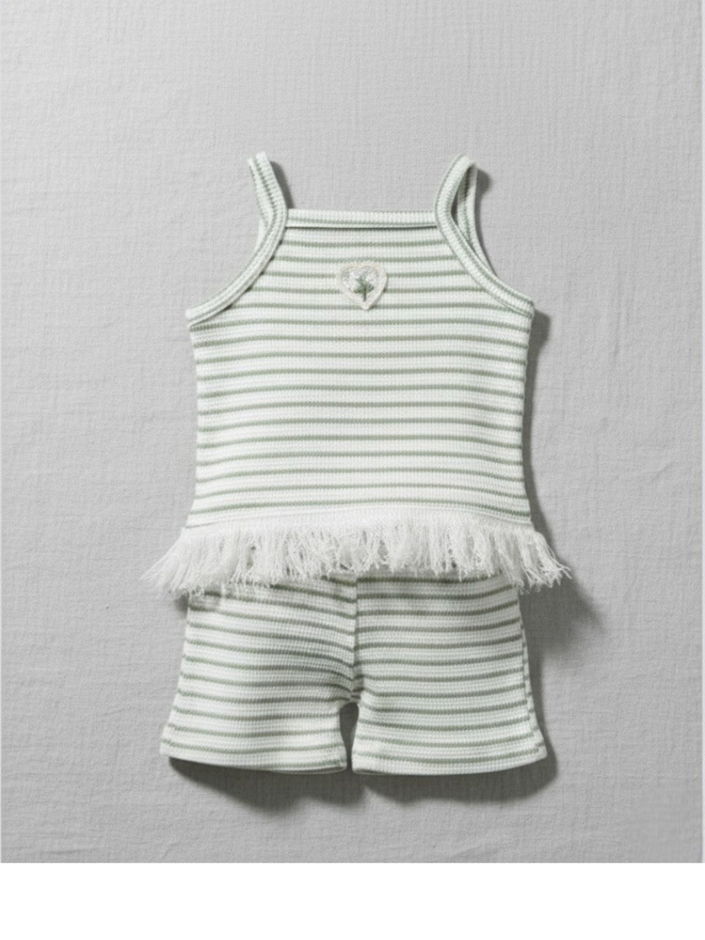 Striped baby outfit with tank top and shorts on a gray background