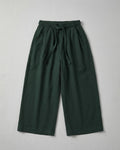 Kids deep forest green wide-leg trousers with an elasticated drawstring waistband displayed on a neutral white background.