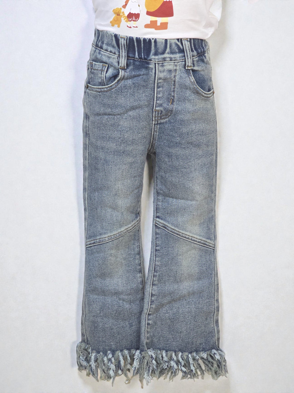 Pair of blue jeans with frayed hems on a white background