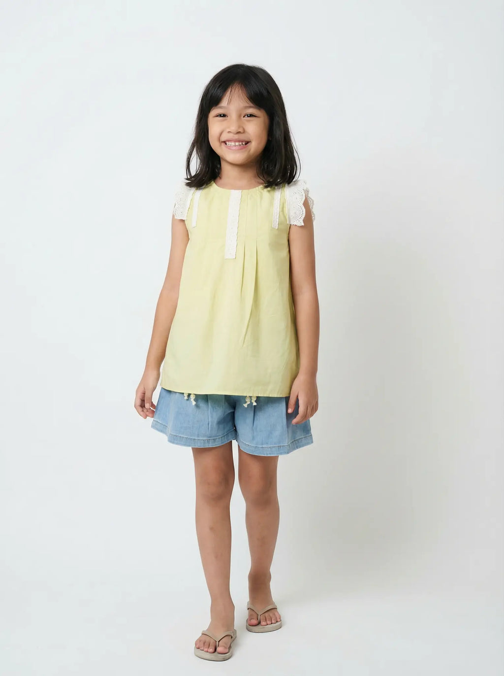 Girls soft yellow sleeveless top - white lace trim and pleated detail. Elegant cotton boutique clothing Australia. Quality spring partywear for ages 2-10.