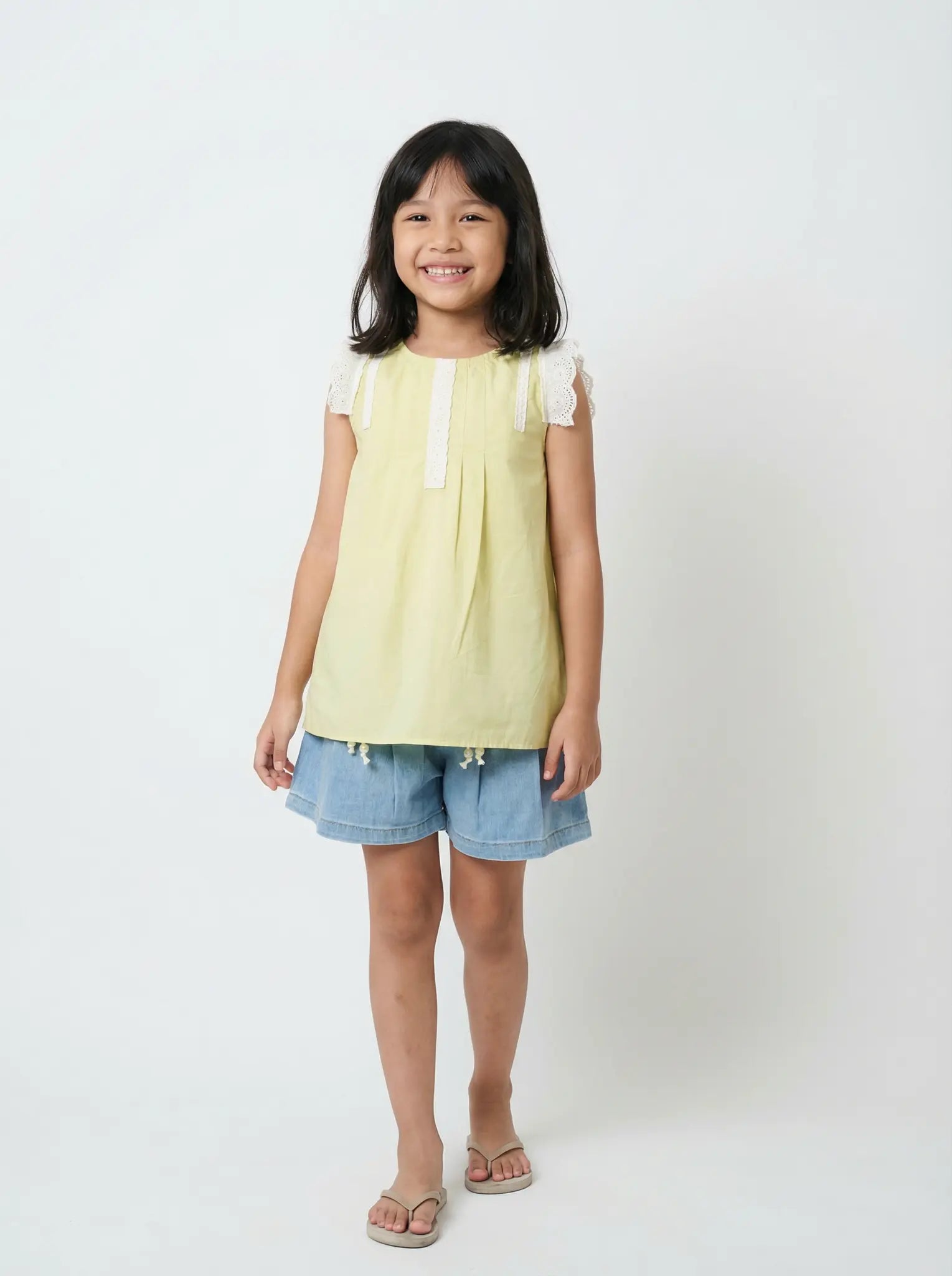 Girls soft yellow sleeveless top - white lace trim and pleated detail. Elegant cotton boutique clothing Australia. Quality spring partywear for ages 2-10.