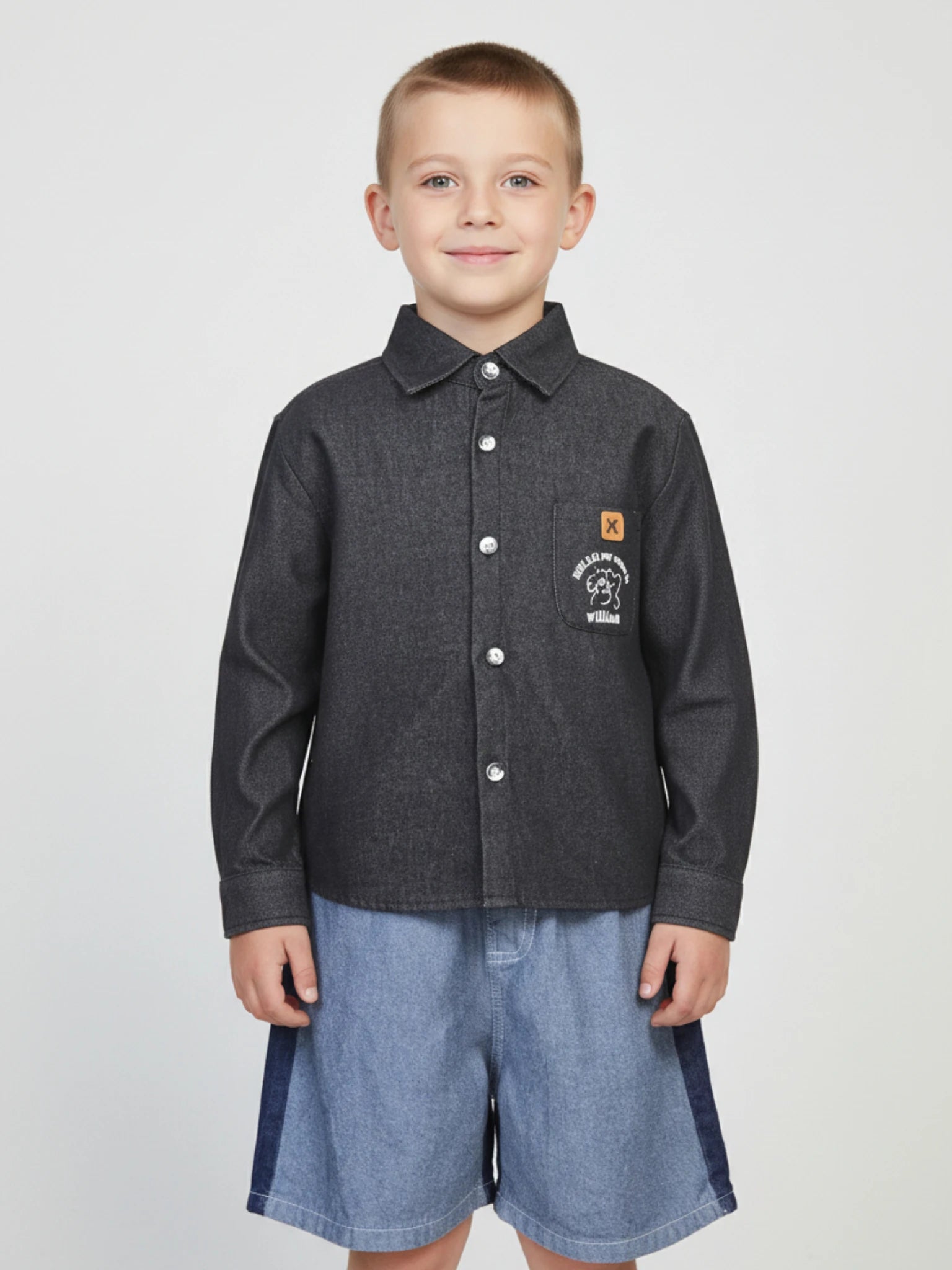 Kids charcoal grey long sleeve button-down shirt featuring a puppy graphic and "William" embroidered on the chest pocket with a tan brand patch.