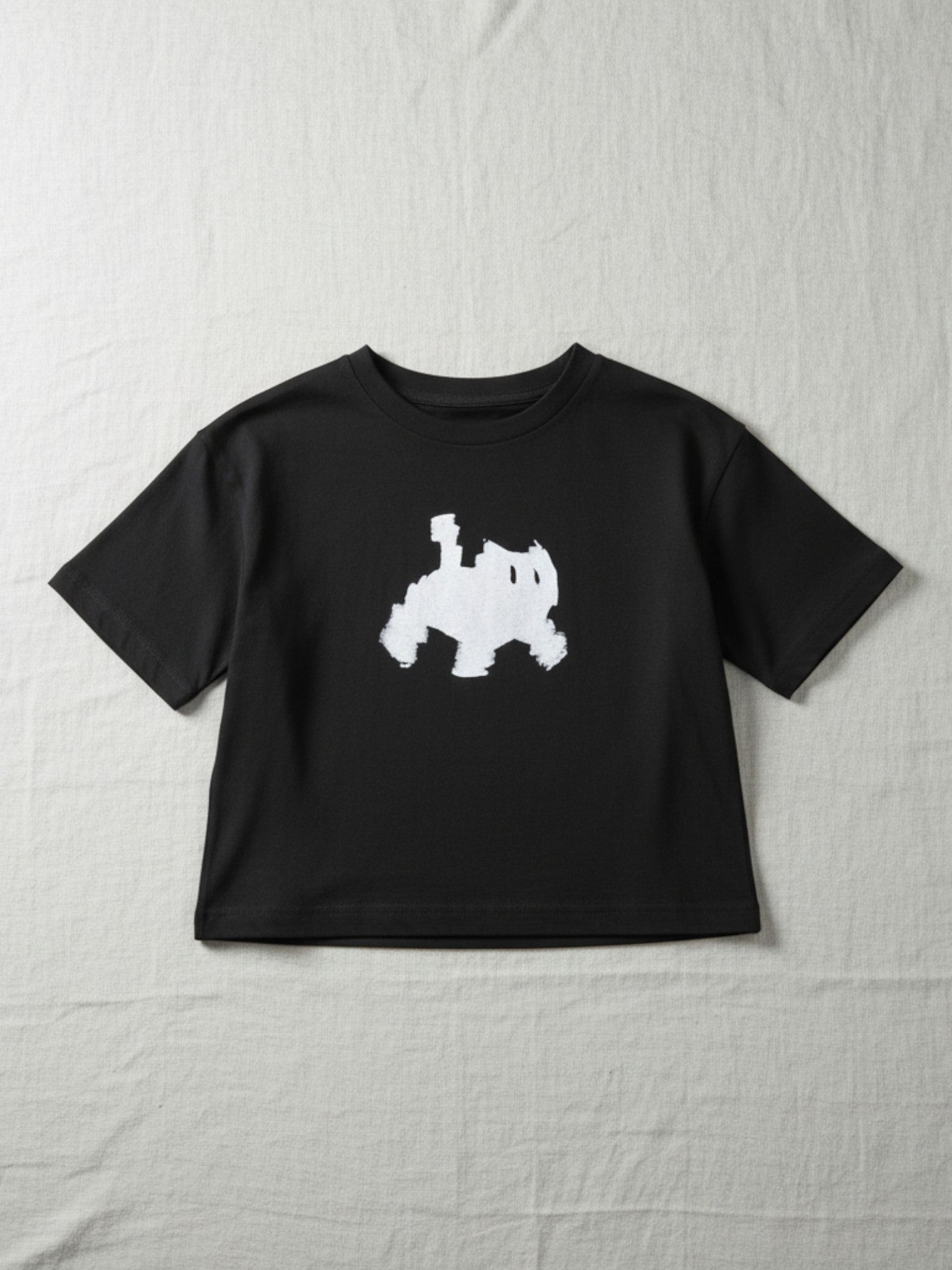 Black t-shirt with a white graphic on a textured white background