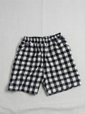 Black and white checkered shorts on a light gray background