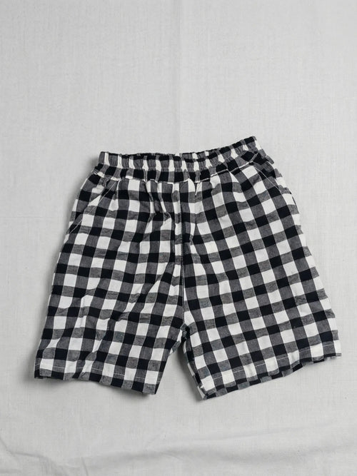 Black and white checkered shorts on a light gray background
