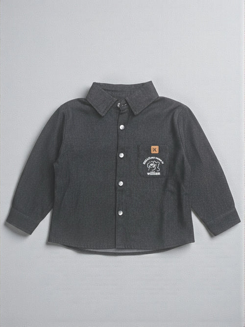 Kids charcoal grey long sleeve button-down shirt featuring a puppy graphic and "William" embroidered on the chest pocket with a tan brand patch.