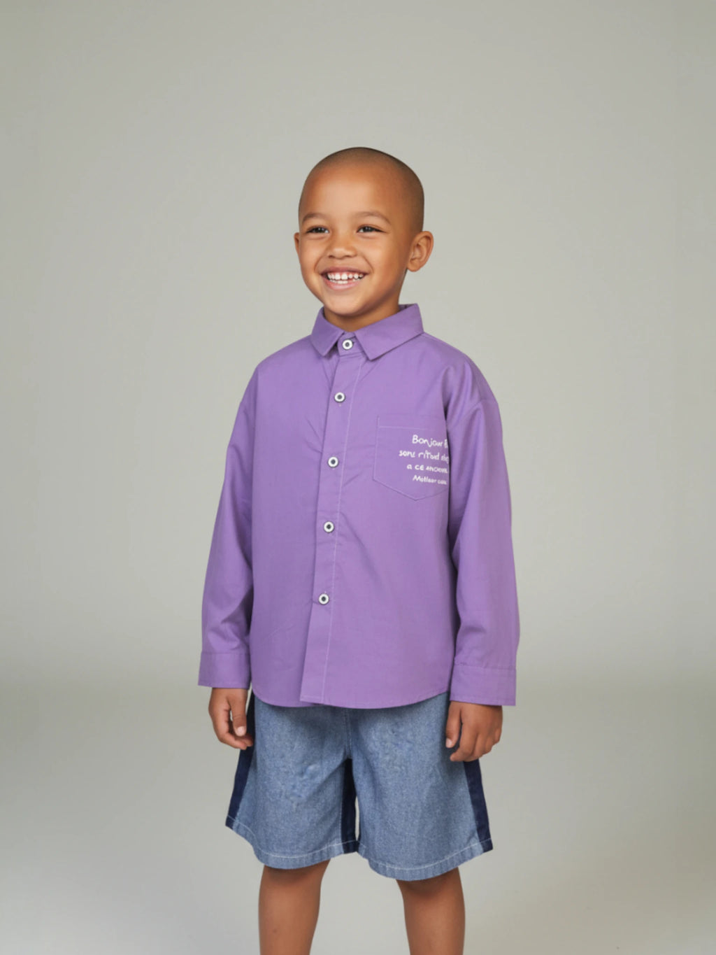 Kids purple long sleeve button-down shirt with a "Bonjour" script print on the chest pocket 