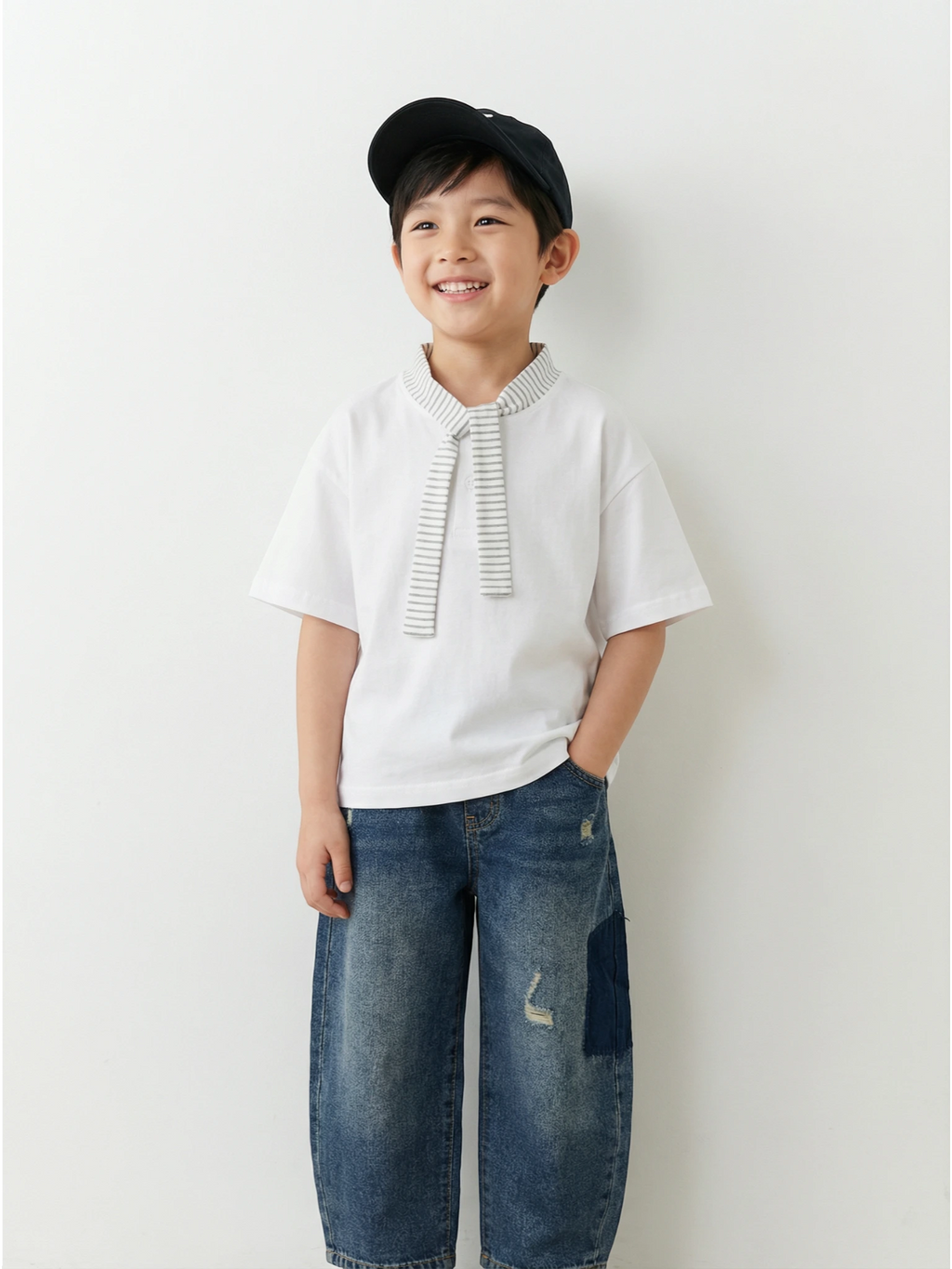 Child wearing a white shirt with a tie and blue jeans against a white background