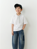 Child wearing a white shirt with a tie and blue jeans against a white background