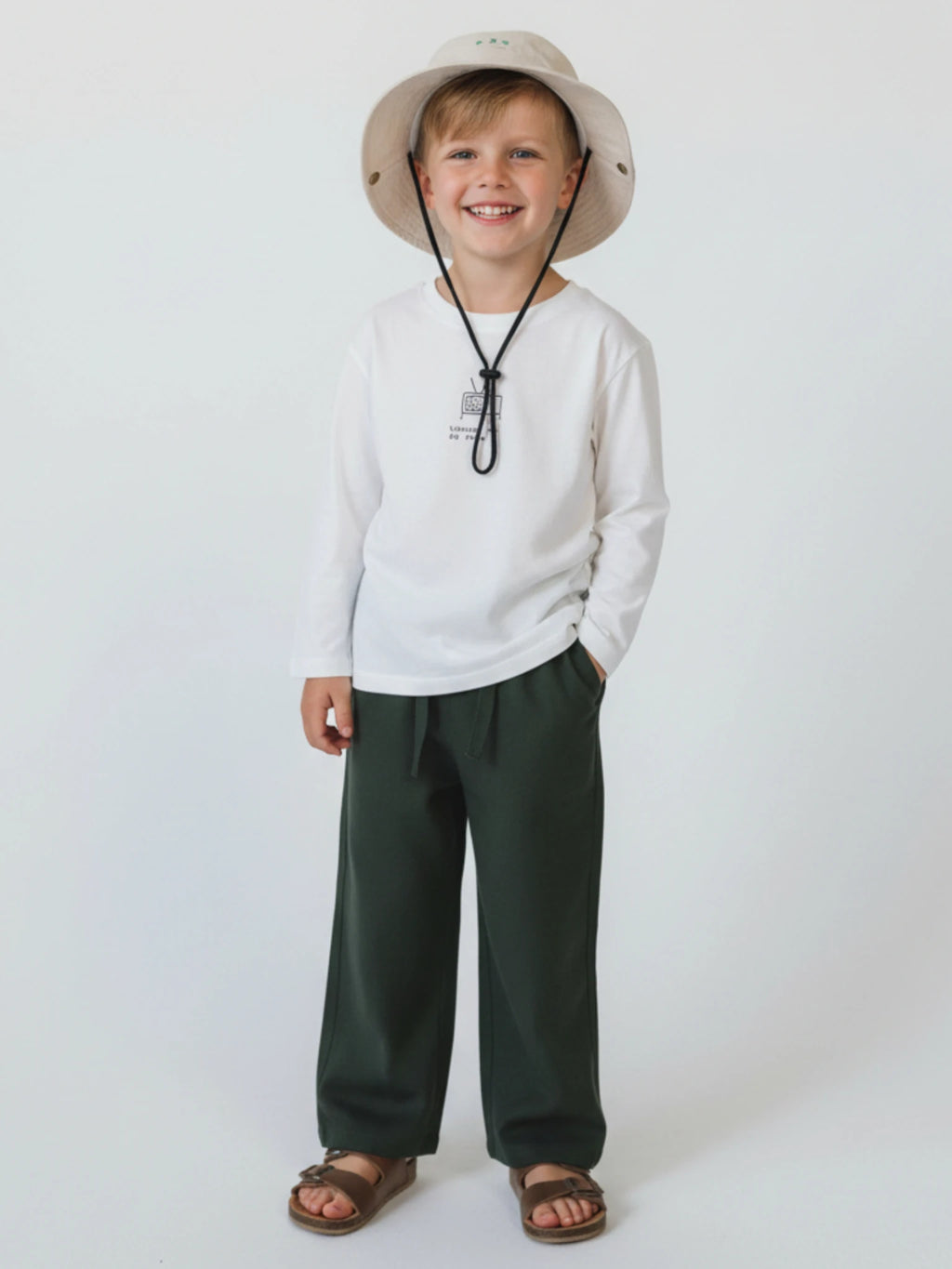 Kids deep forest green wide-leg trousers with an elasticated drawstring waistband displayed on a neutral white background.