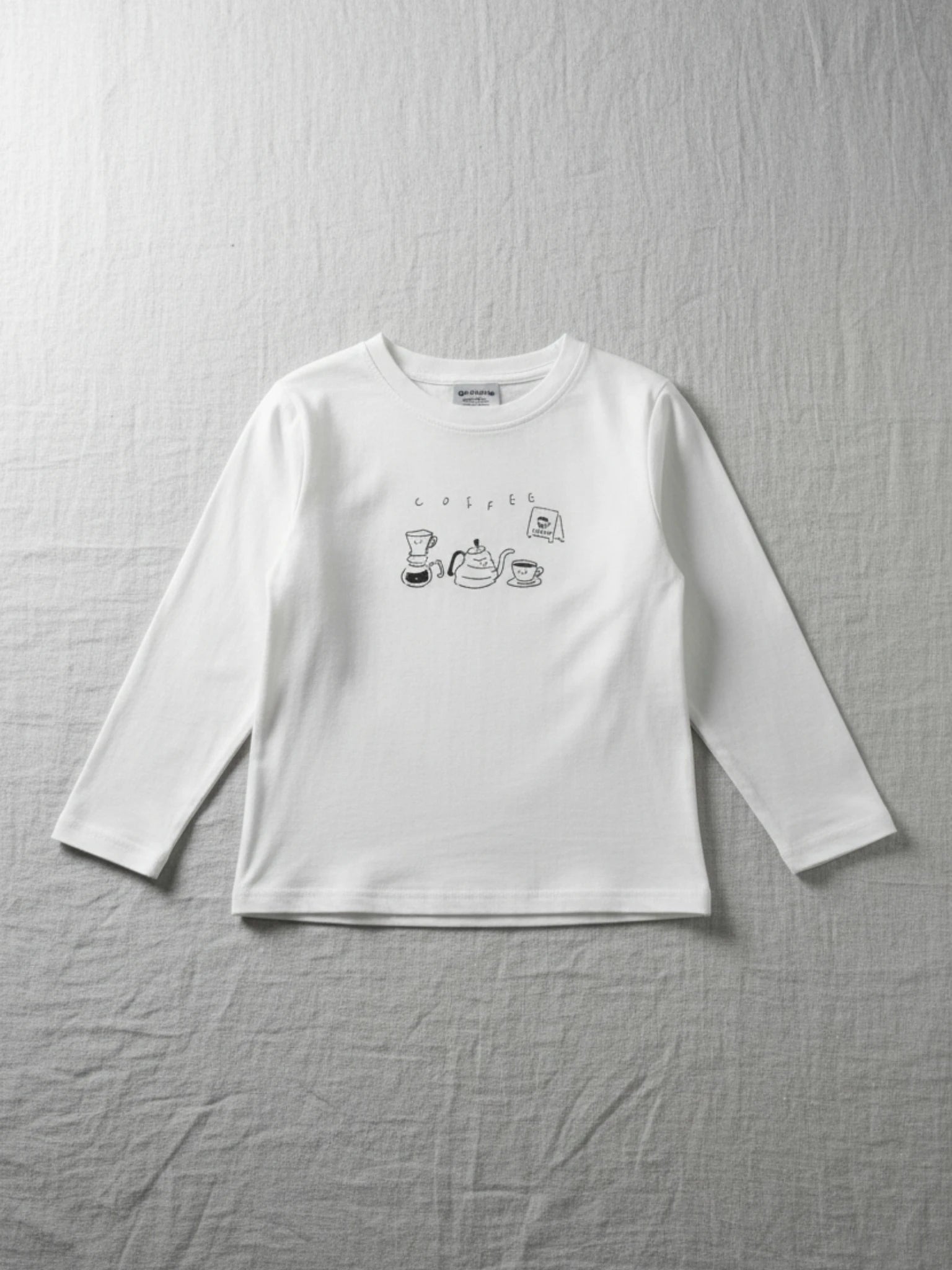 Half Moon Clothing kids' white long-sleeve t-shirt with a minimalist black coffee-themed graphic, comfortable and durable for year-round wear."