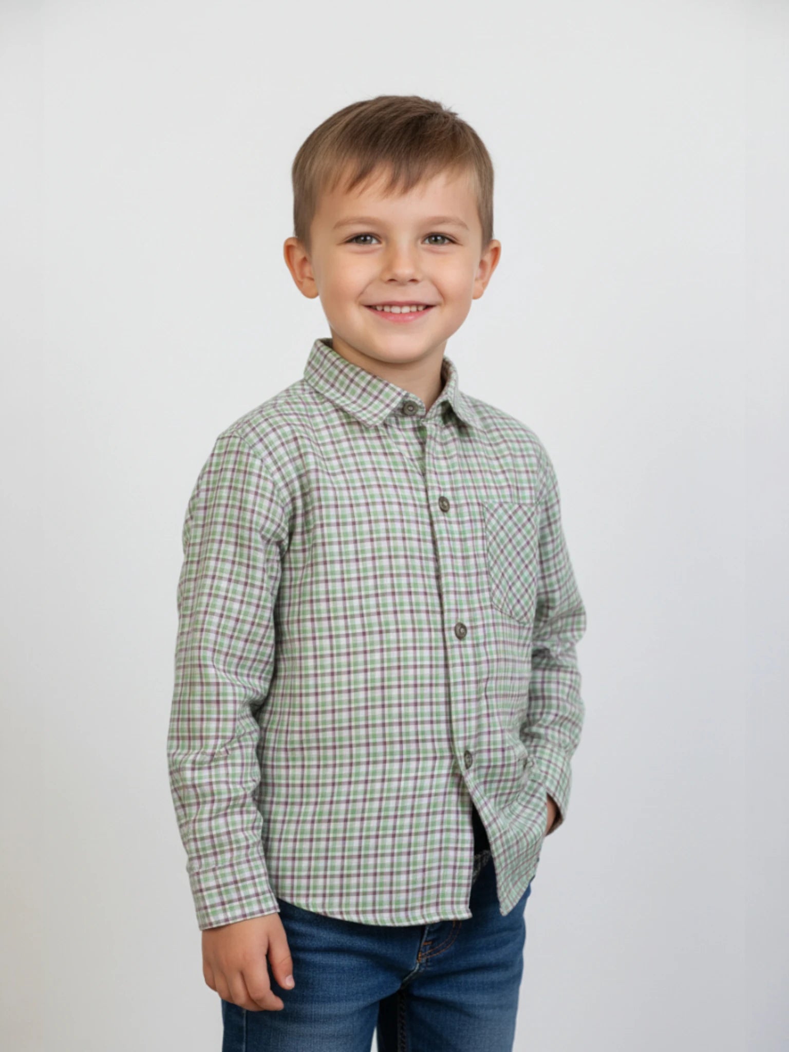 Kids long sleeve button-down shirt featuring a emerald gingham check pattern and a chest pocket on a textured background.